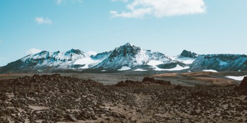 rocky valley in front of mountains ridge